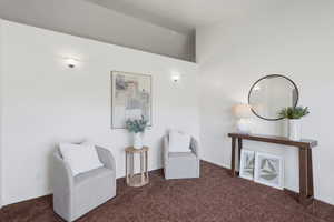 Living area with carpet and baseboards