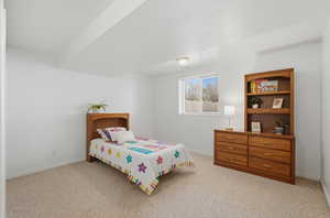 Bedroom featuring light colored carpet and baseboards