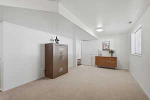 Unfurnished bedroom with light carpet and baseboards
