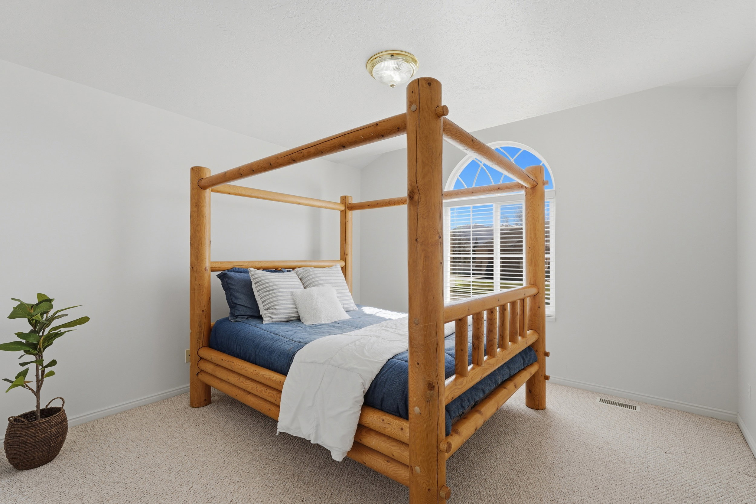 Bedroom featuring light colored carpet and baseboards