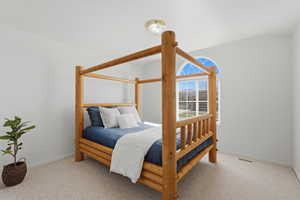 Bedroom featuring light colored carpet and baseboards