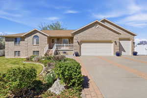 Ranch-style house with driveway, a porch, an attached garage, and brick siding