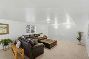 Living room featuring baseboards and light colored carpet