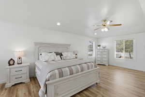 Bedroom featuring light wood finished floors, ceiling fan, and recessed lighting