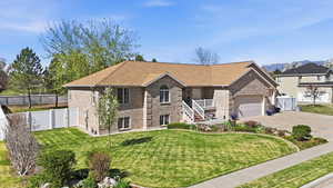 View of front of home with brick siding, roof with shingles, concrete driveway, and a garage