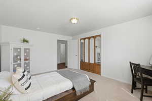 Carpeted bedroom with baseboards