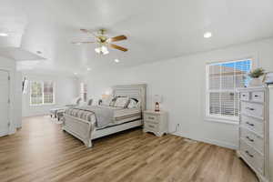 Bedroom with light wood finished floors, a ceiling fan, and recessed lighting