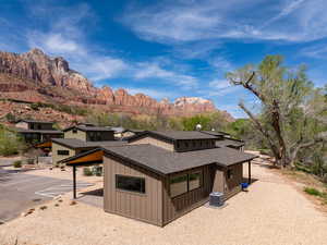 View of front of property with roof with shingles, a mountain view, and board and batten siding