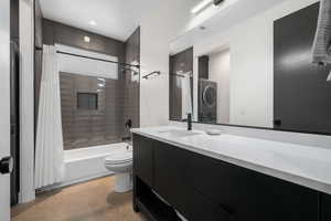 Full bathroom featuring vanity, shower / bath combination with curtain, and concrete floors