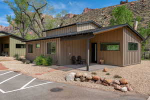 View of front facade with board and batten siding, a patio area, and a mountain view