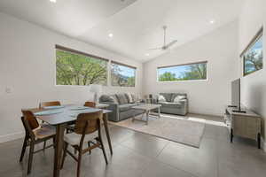 Dining room featuring healthy amount of natural light, ceiling fan, recessed lighting, and lofted ceiling