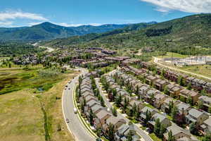Aerial perspective of suburban area featuring a mountainous background