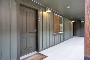 View of exterior entry featuring board and batten siding