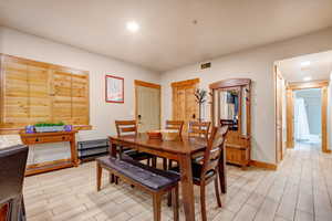 Dining room featuring recessed lighting and wood tiled floors