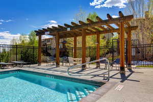 Community pool with a pergola and a patio
