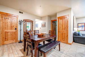 Dining space with wood finish floors and baseboards