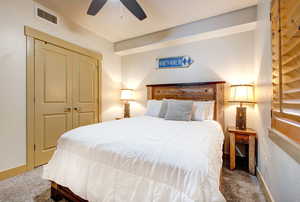 Bedroom featuring carpet floors, a ceiling fan, and a closet