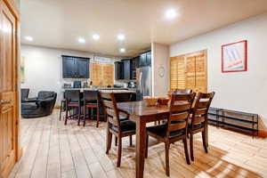 Dining space with wood finish floors and recessed lighting