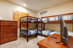Bedroom featuring light colored carpet