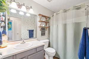 Bathroom with vanity and curtained shower