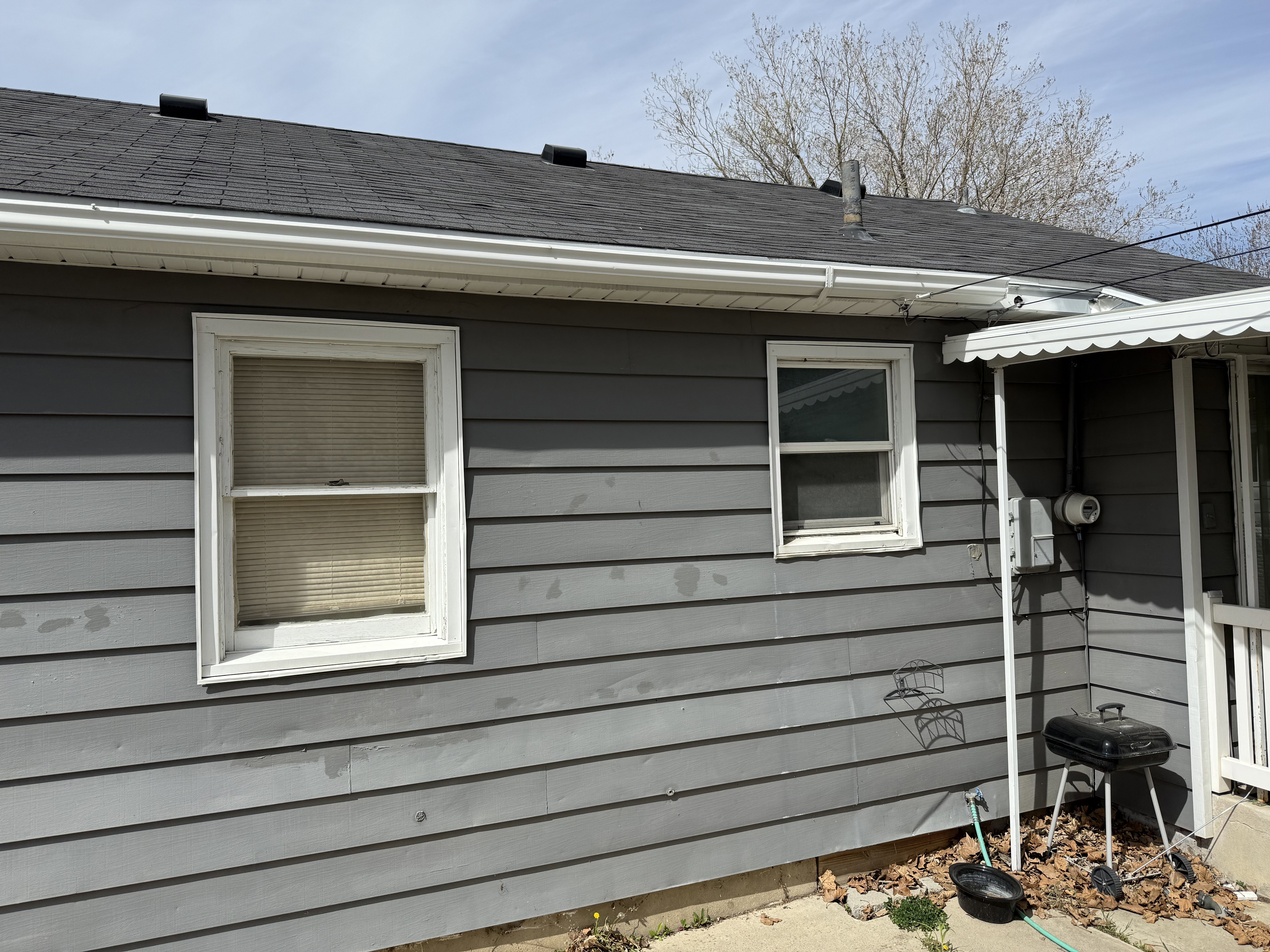 View of side of property featuring a shingled roof