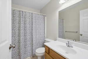 Full bath featuring vanity, a shower with shower curtain, and light tile patterned floors