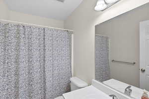 Full bath featuring vanity and a shower with curtain