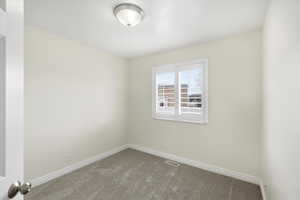 Spare room with carpet floors and baseboards