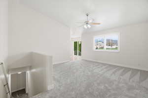 Spare room with light colored carpet and ceiling fan