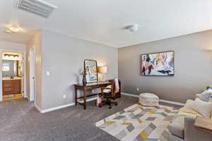 Home office with carpet and baseboards