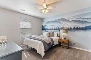 Bedroom featuring a ceiling fan and carpet floors