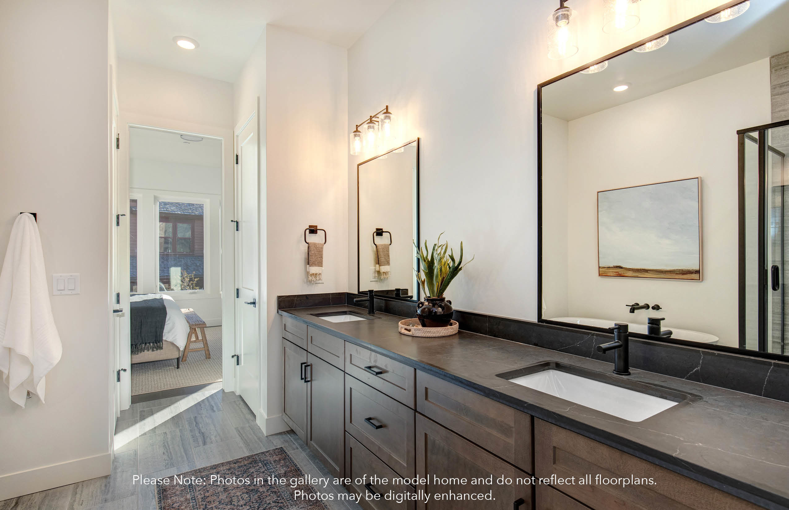 Ensuite bathroom featuring double vanity, light wood-style floors, and recessed lighting