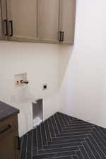 Laundry room featuring cabinet space, hookup for a washing machine, and electric dryer hookup