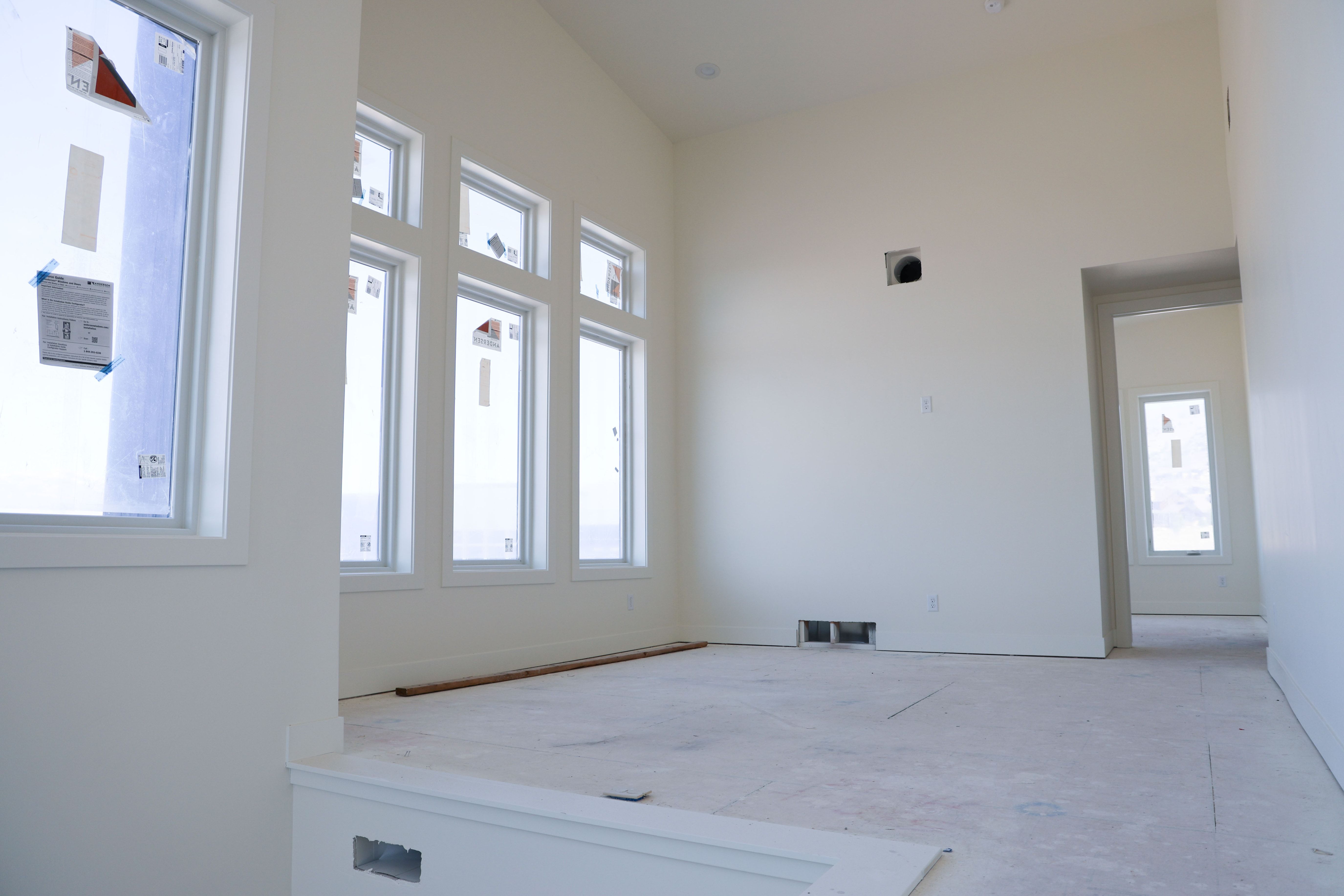 Unfurnished room with a high ceiling