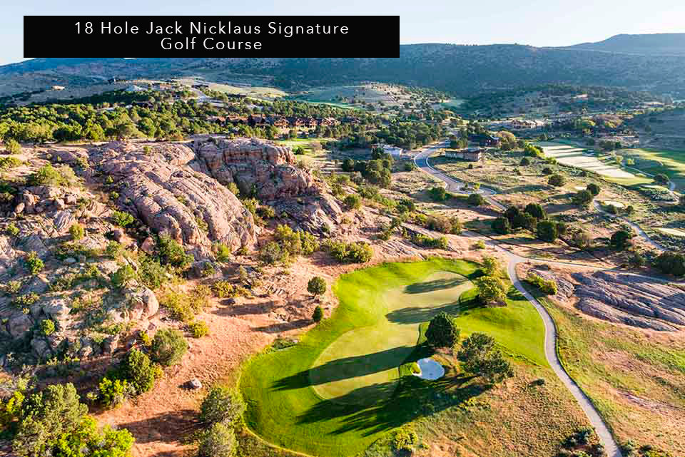Drone / aerial view of mountains and a golf club