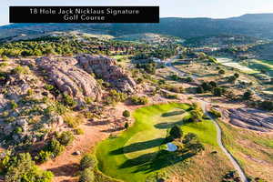 Drone / aerial view of mountains and a golf club