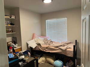 Bedroom featuring a textured ceiling and carpet floors
