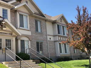 View of front facade featuring a front yard and stucco siding