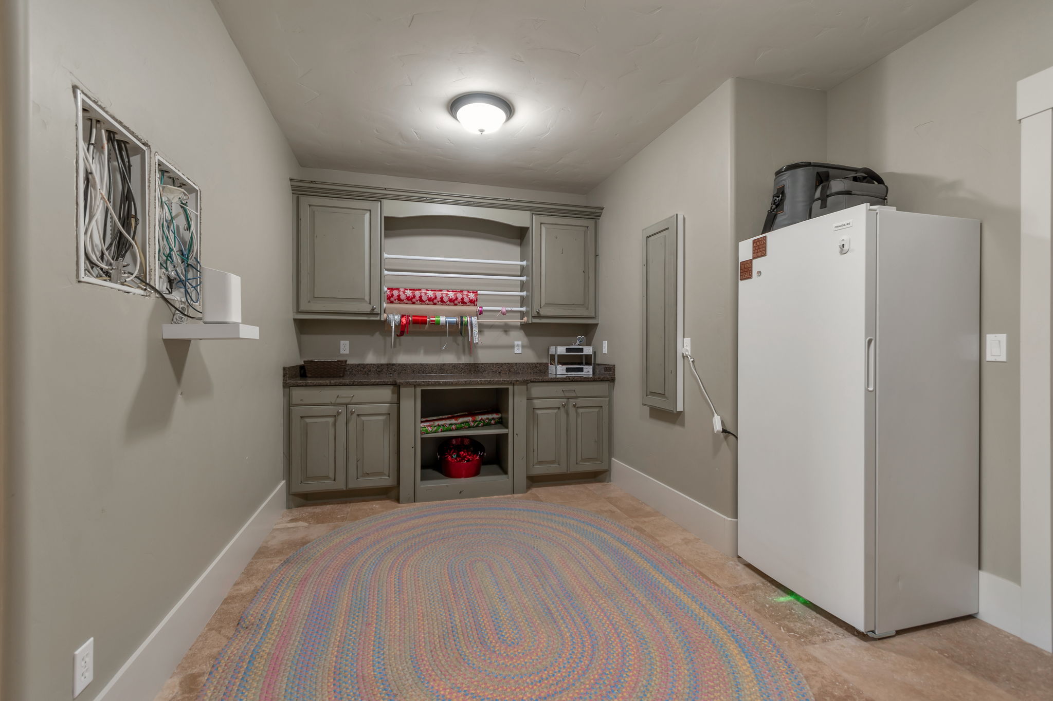 Bar with freestanding refrigerator, dark countertops, and gray cabinets