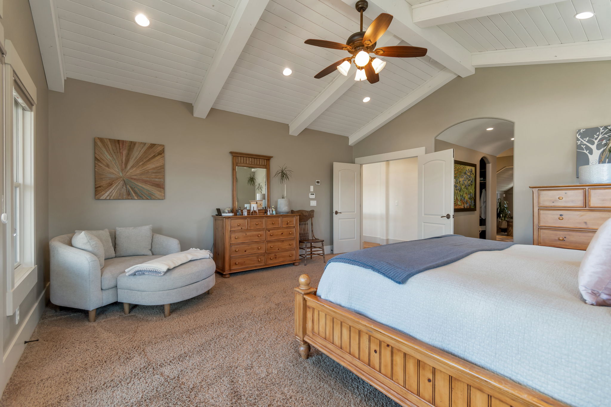 Bedroom featuring recessed lighting, a ceiling fan, carpet floors, beamed ceiling, and arched walkways