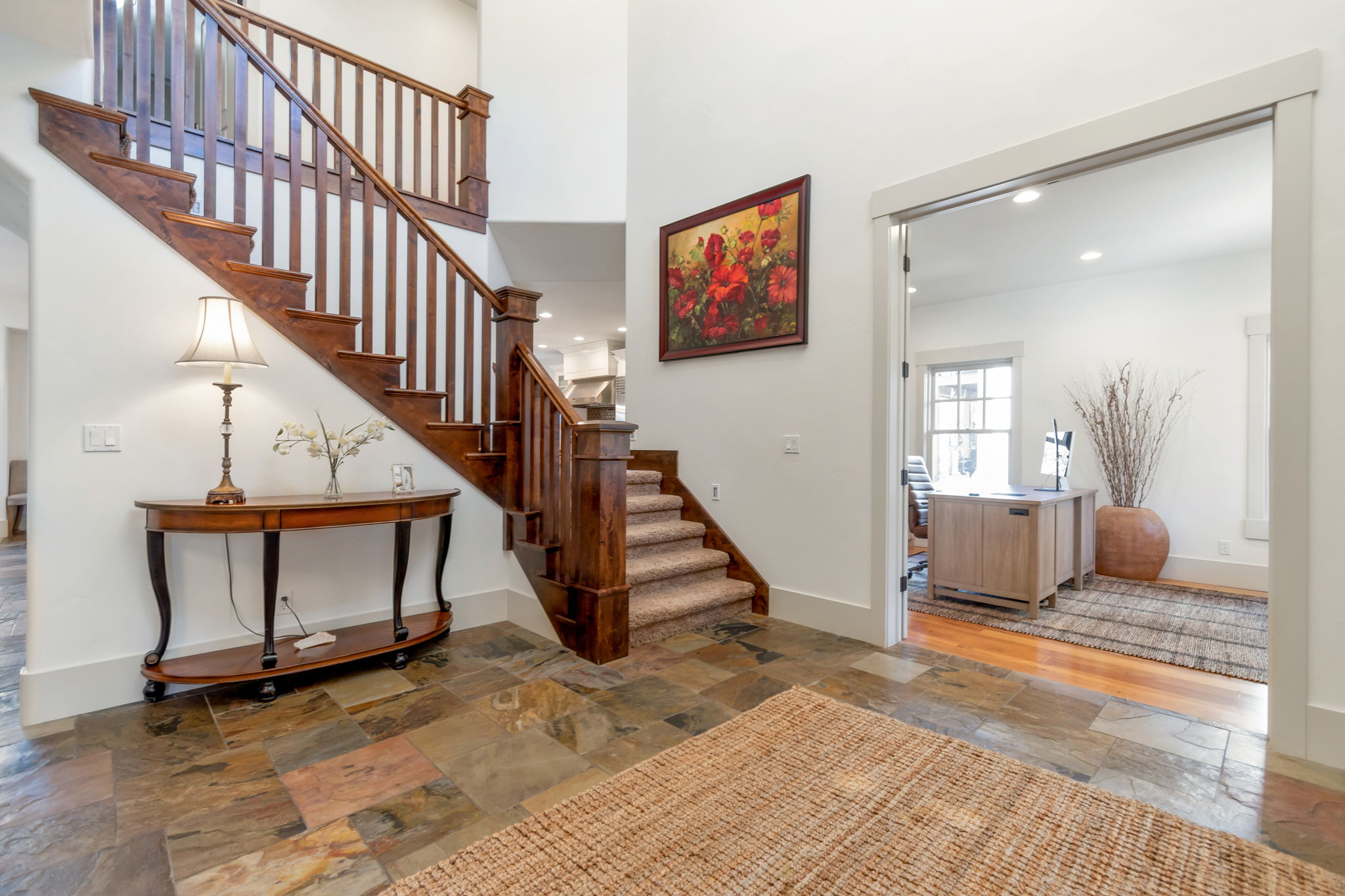 Stairway with stone tile floors, recessed lighting, and a high ceiling