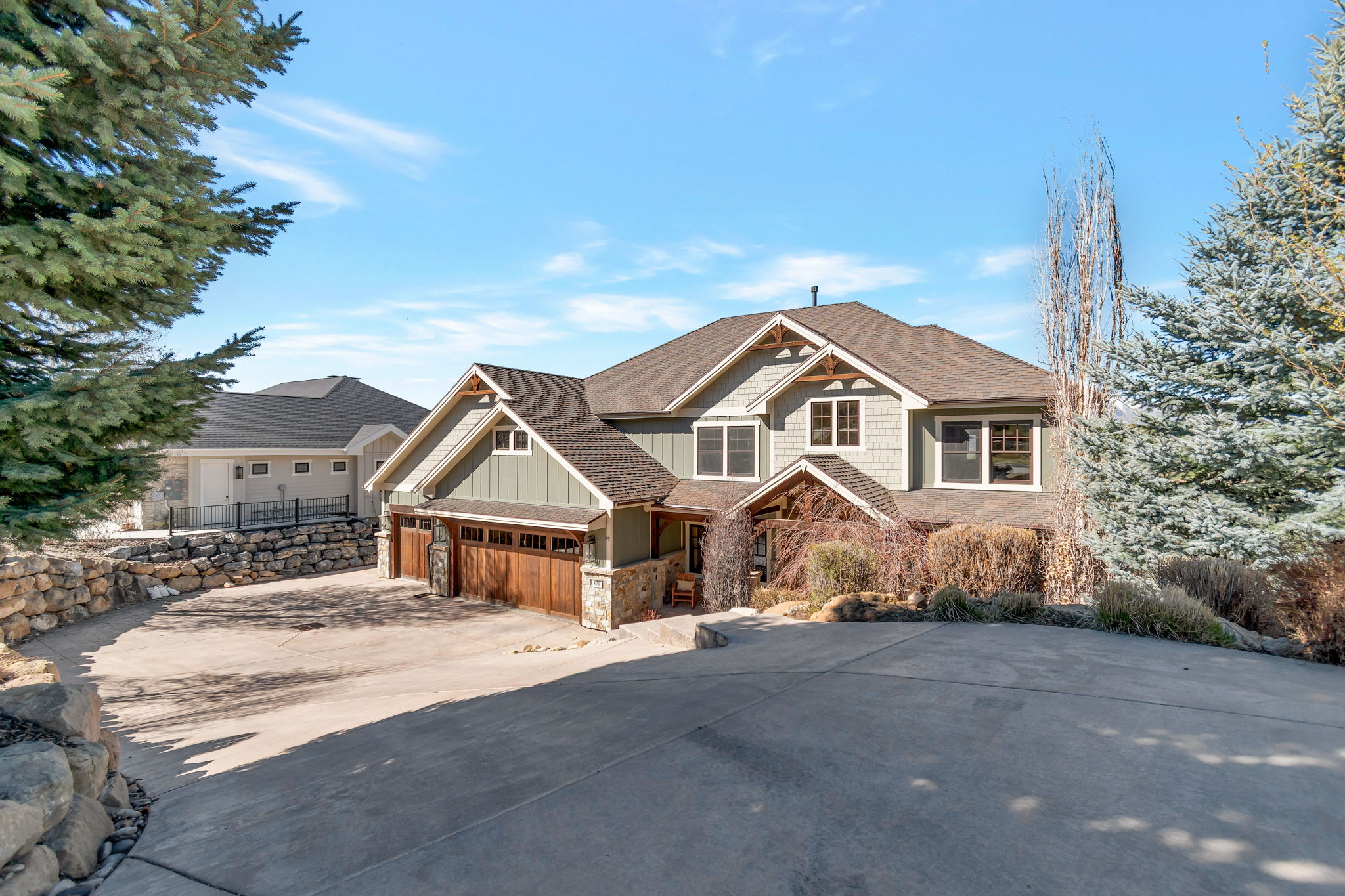Craftsman house with board and batten siding and concrete driveway