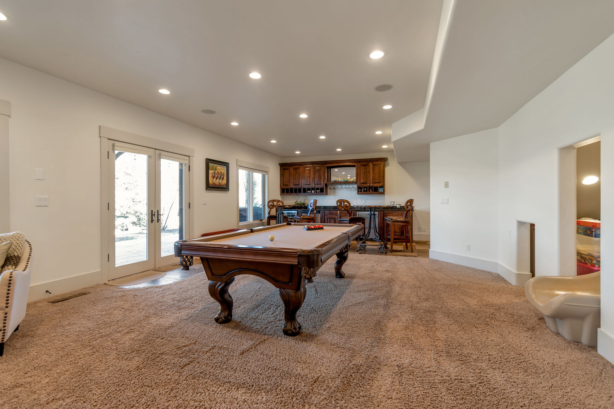 Recreation room featuring bar with sink, light carpet, recessed lighting, french doors, and pool table