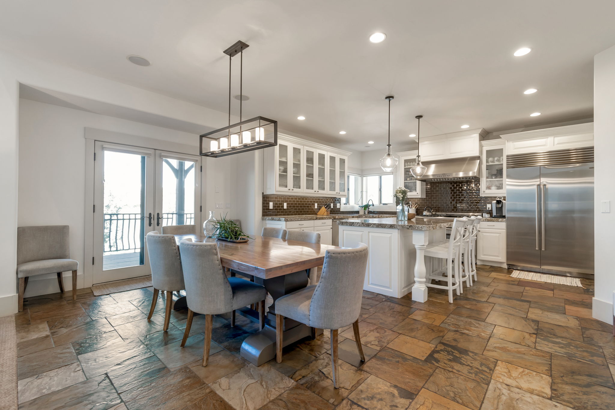 Dining area with recessed lighting and stone tile floors