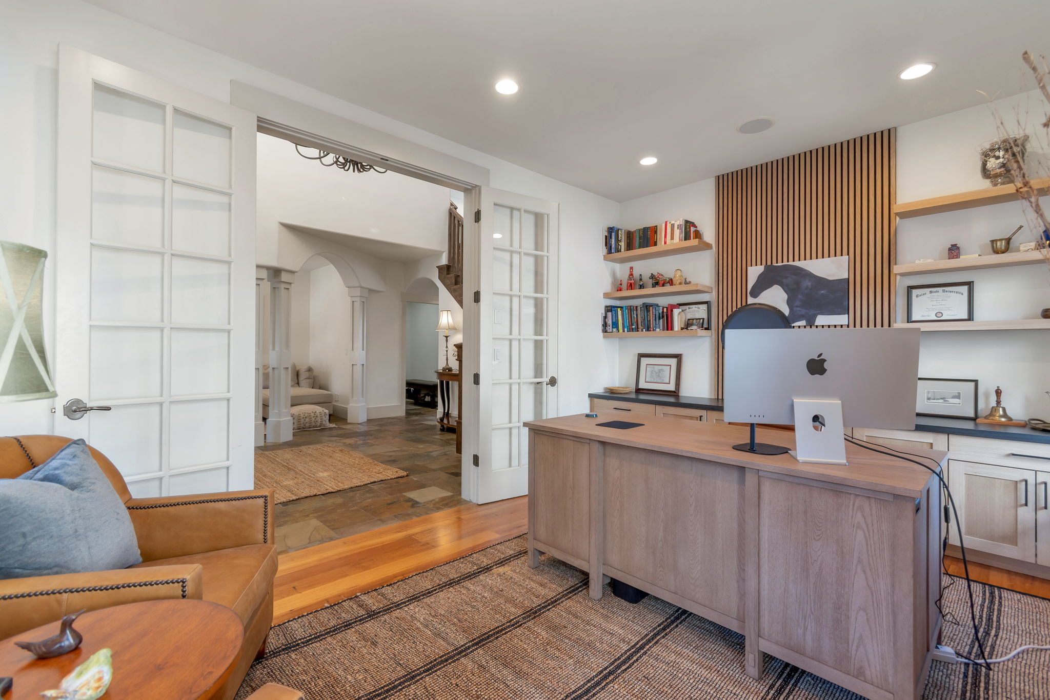 Home office featuring french doors, arched walkways, light wood finished floors, decorative columns, and recessed lighting