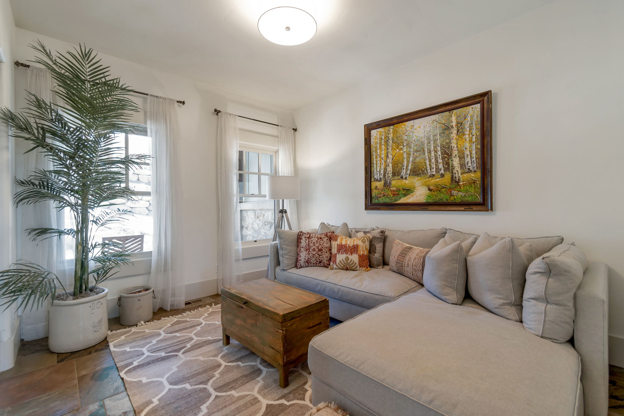 Living room featuring baseboards and stone finish floors