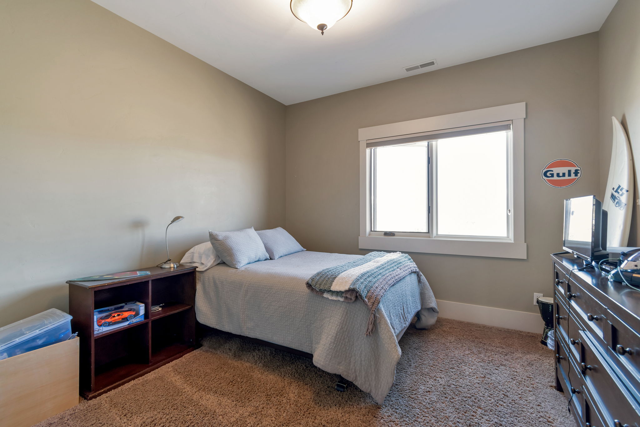 Bedroom with dark colored carpet and baseboards