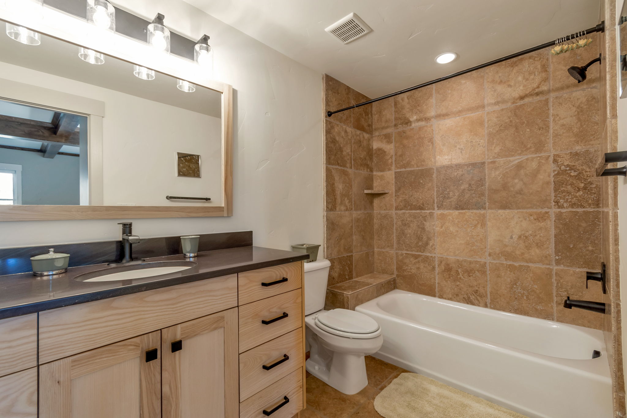 Bathroom with vanity, tub / shower combination, and recessed lighting