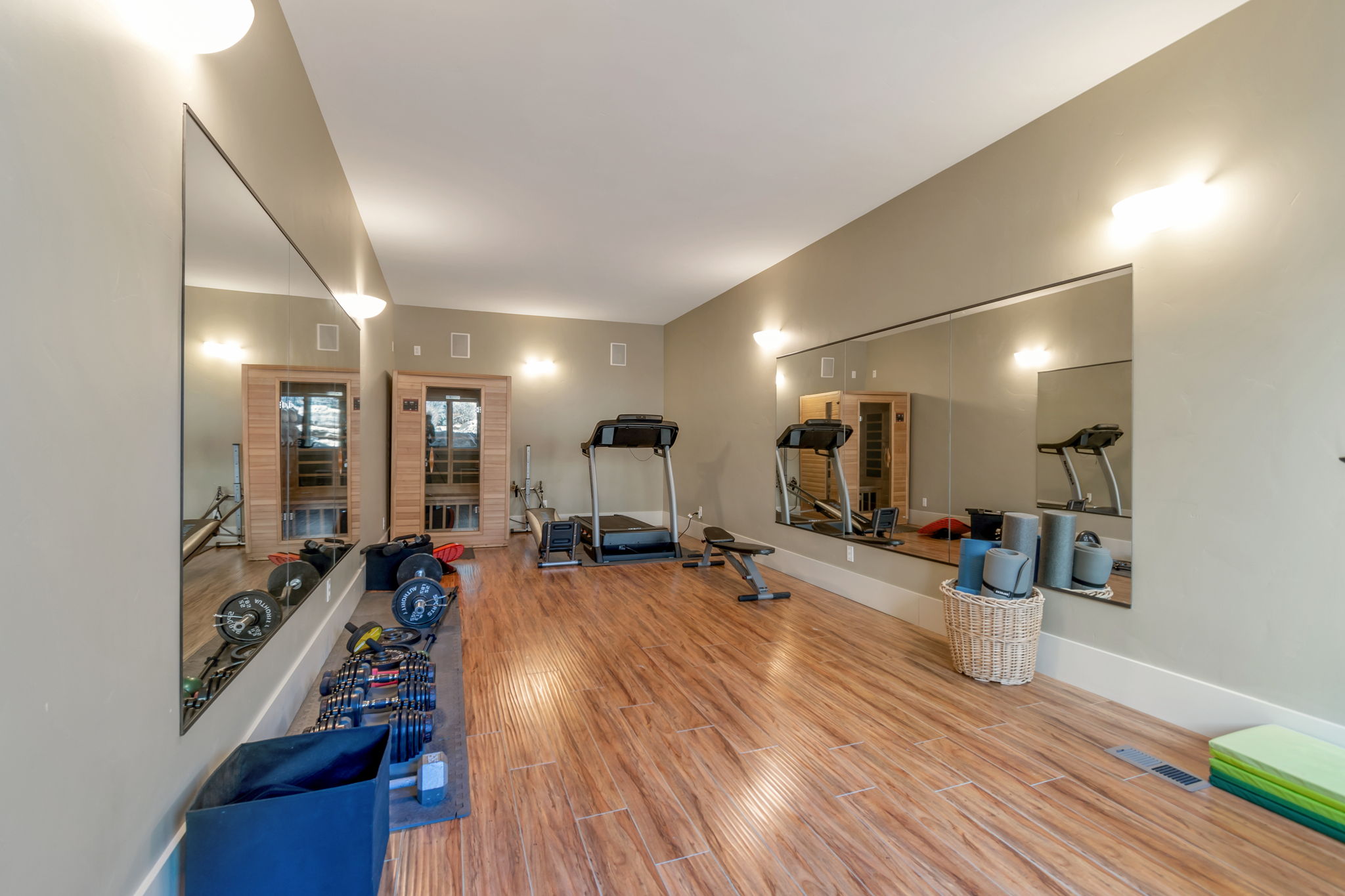 Workout room featuring light wood-type flooring and baseboards