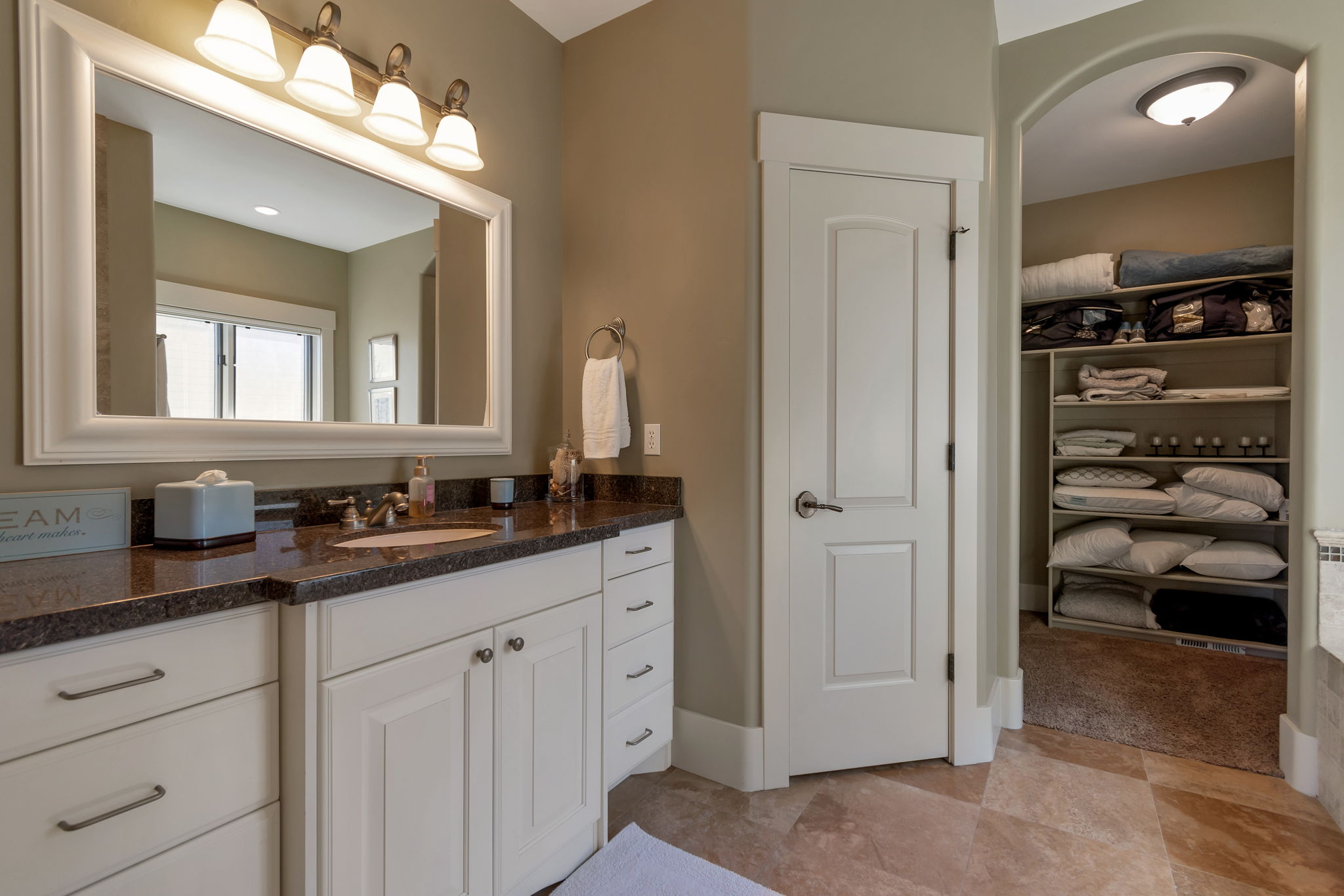 Full bathroom featuring a walk in closet and vanity